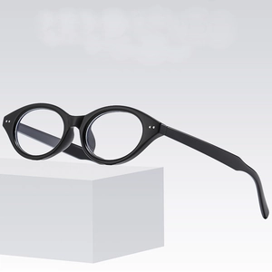 Classic black oval glasses with silver rivets on a white pedestal, retro chic eyewear