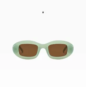 Detail view of oval jelly green frames with dark brown lenses for retro sunglasses