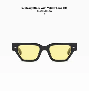 Détail frontal de lunettes de soleil noires à verres jaunes et rivets métalliques