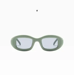 Macro detail of oval vintage green sunglasses with light gray lenses in style C06
