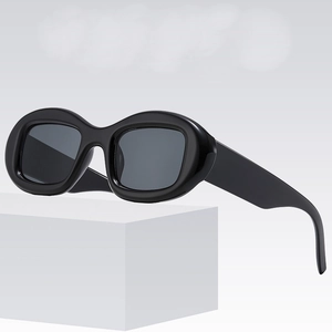 Retro oval sunglasses with thick black frames and dark grey lenses in minimalist style