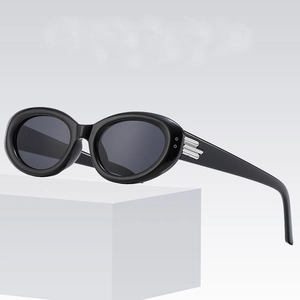 Retro black oval sunglasses with silver metal accents on a clean display stand