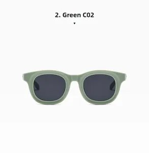 Detail of matte green oval frame sunglasses with dark grey lenses in a minimalist style