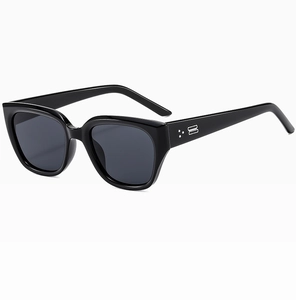 Detail of square black sunglasses showing shiny frame finish and side metal decoration