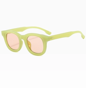 Detail view of fluorescent yellow retro sunglasses with peach lenses and silver rivets
