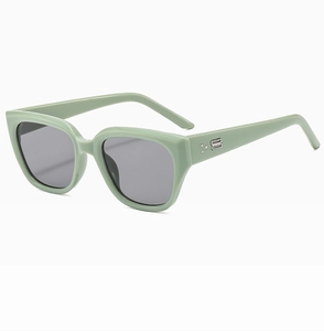 Detailed close-up of mint green square sunglasses with metal hinges and rivet accents