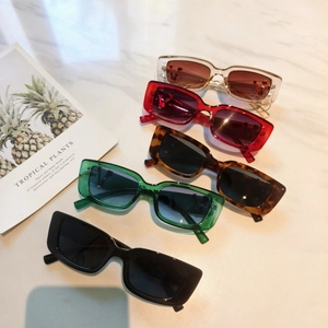 Detail view showing five retro narrow rectangular sunglasses in various stylish colors
