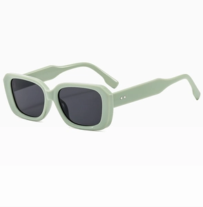 Detail view of mint green rectangular sunglasses with silver diamond stud accents