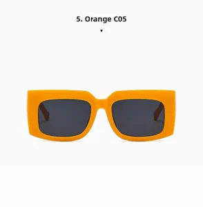Detailed view of trendy orange rectangular sunglasses with thick frames and dark lenses