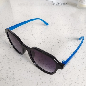 Trendy square sunglasses with black frame, blue temples, and purple gradient lenses