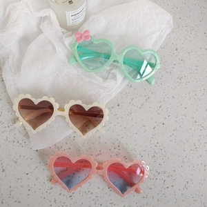 Kids heart-shaped sunglasses set in pastel mint, cream, and pink with stylish frames