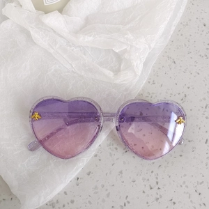 Detail of heart sunglasses with gradient lenses, glitter frame and gold bee accents