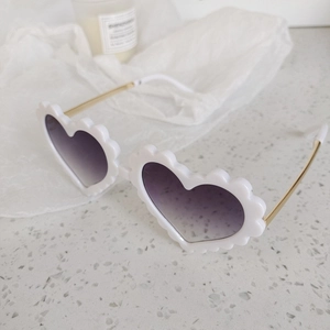 White scalloped heart sunglasses with gold metal temples and gradient purple-gray lenses