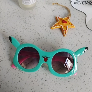 Retro butterfly cat-eye kids sunglasses featuring a cute green cartoon character design