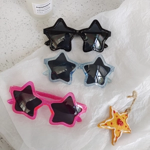 Cute star-shaped kids sunglasses in pink, blue and black with glitter frames