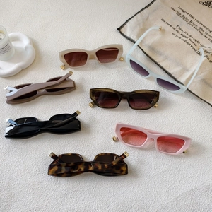 Pink vintage cat-eye sunglasses with thick frames and golden temple accents in various colors