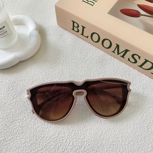 Detail of gradient tea lenses and light khaki square frame sunglasses on artistic background