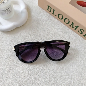 Detail of square vintage sunglasses with purple gradient lenses and gold accents