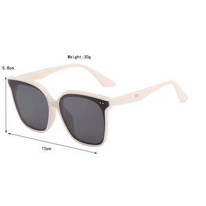 Detail view of square cream-white sunglasses with dimensions 15cm width and 30g weight