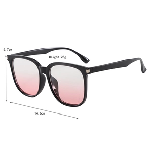 Detail view of oversized sunglasses featuring black frames and pink gradient lenses