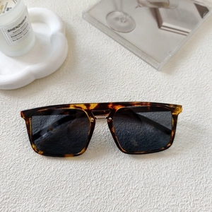 Close-up of tortoise shell sunglasses with dark lenses and elegant metal nose bridge