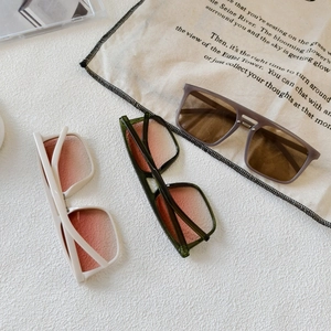 Three pairs of stylish oversized square sunglasses in white, green, and grey colors
