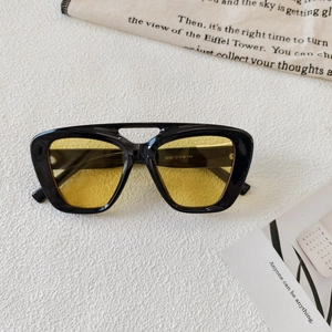 Close-up of retro double-bridge pilot sunglasses with yellow lenses and 13157 model specs