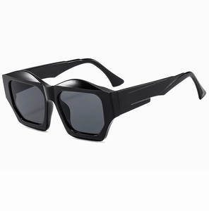 Close-up of geometric black sunglasses with thick frames and unique wavy bridge design