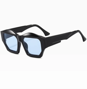 Detail view of thick black geometric frame and light blue lenses of modern sunglasses