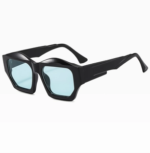 Detailed view of irregular geometric black sunglasses with light blue transparent lenses