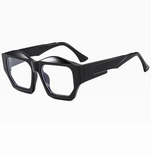 Close-up of black chunky irregular polygonal frames with glossy finish and clear lenses
