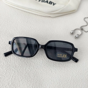 Detailed shot of retro rectangular sunglasses with UV400 protection and CE mark labels