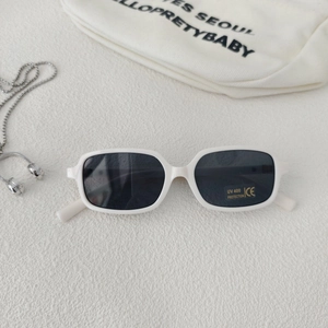 Detail of white rectangular children's sunglasses with UV400 lenses and silver chain