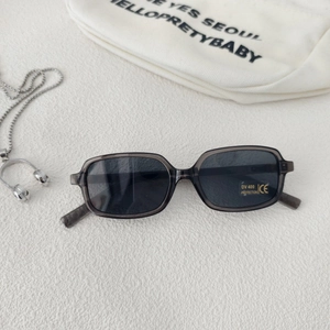 Detail of grey transparent square kids sunglasses with UV400 protection lens and label