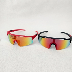 Détail de lunettes de cyclisme enfant rouges et noires avec verres irisés colorés