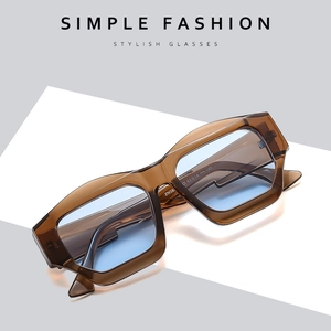 Chic cat-eye sunglasses with amber frames and light blue lenses in a minimalist layout