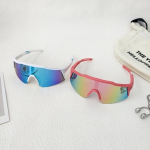 Close-up of kids sports sunglasses with white and pink frames and reflective lenses