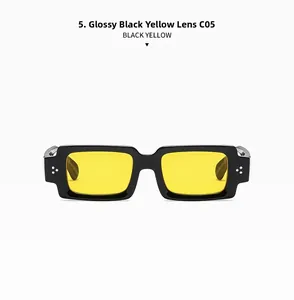 Detail of retro rectangular sunglasses with bright black frames and yellow lenses