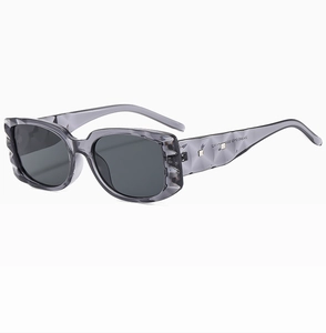 Detailed close-up of rectangular sunglasses with 3D diamond-patterned textured temples