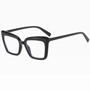 Detail of black cat-eye eyeglass frames with wide rims and integrated nose pads
