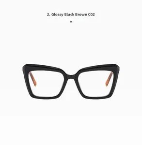 Detail of cat-eye glasses frame featuring glossy black front and amber brown temples