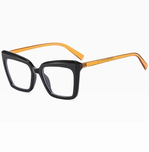 Detail view of large cat-eye glasses with black glossy front and amber tortoise temples