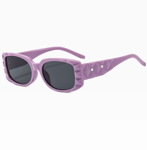 Detail of purple square sunglasses with 3D geometric texture and silver accents