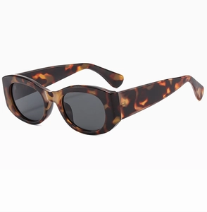 Macro detail of tortoiseshell texture on wide temples of vintage cat eye sunglasses