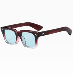 Detail of square gradient burgundy frame with blue lenses and hammer-shaped metal rivets
