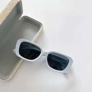 Polarized kids sunglasses in matte blue with a beige textured protective case