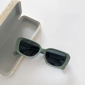 Detail of matte olive green kids polarized sunglasses with a woven texture storage case