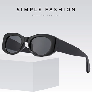 Retro black oval sunglasses with thick frames and wide temples on a minimal white stand