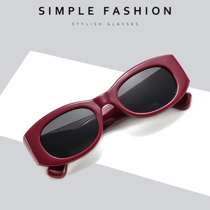 Retro cat-eye sunglasses with thick burgundy frames and UV protection lenses in a studio shot