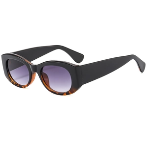 Retro cat eye sunglasses with black and tortoise frames and purple gradient lenses